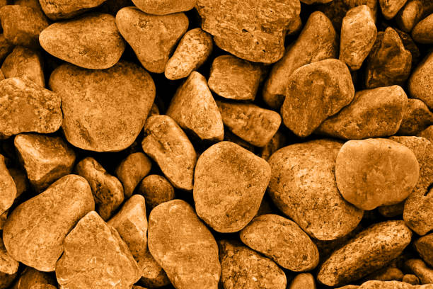 istock Abstract background from different sea stones on the coast.Summer rest concept.Backdrop with copy space.Close up photography.Warm toned. 1387839563