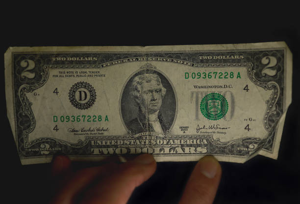 istock Two dollar bill issued in 2003 on black background. 1387839742