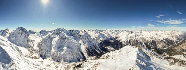 istock view of snowy mountains and sun 1387839903