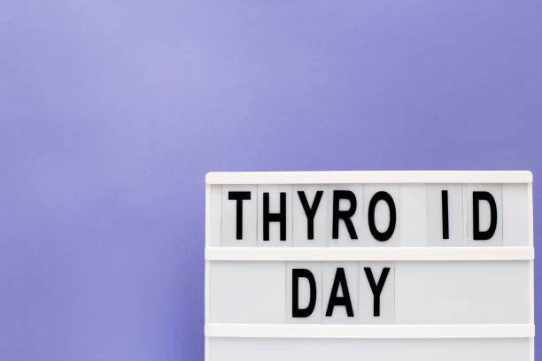 istock inscription international thyroid day on purple background. copy space 1387840142
