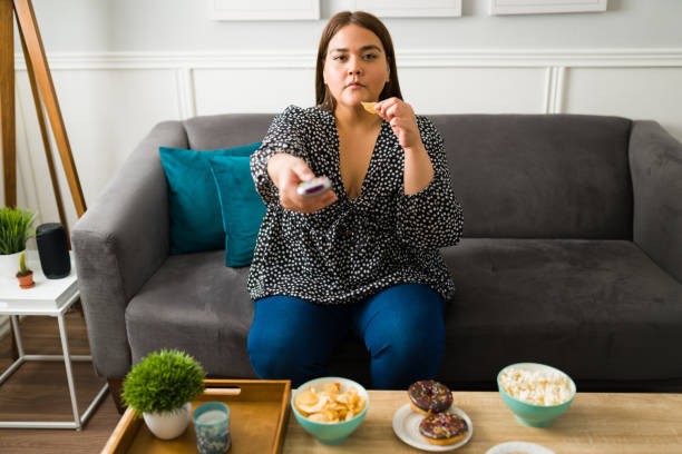 istock Woman with obesity overeating 1387840182