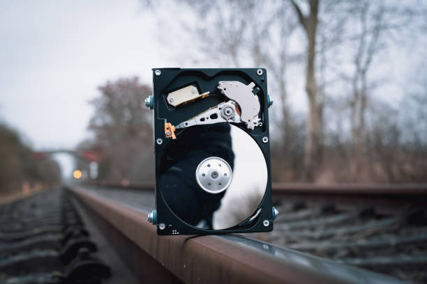 a hard disk stands on the rails of the railroad - bolt nut screw hardware store imagens e fotografias de stock