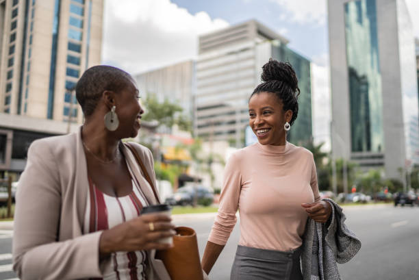 istock Business women talking while walking outdoors 1387843126