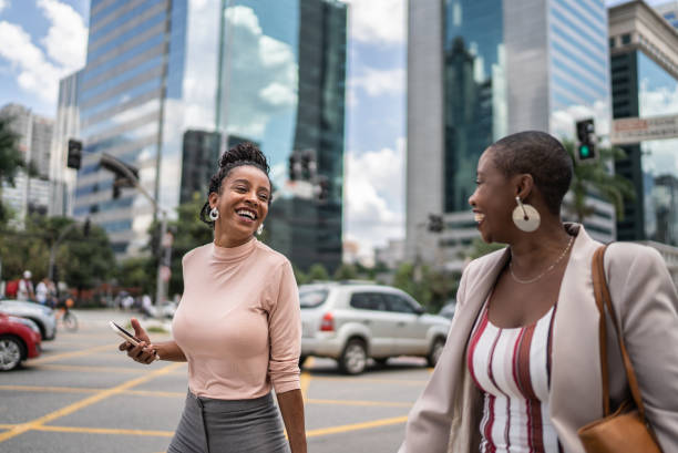 istock Business women talking while walking outdoors 1387843138