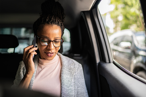 Mature woman talking on the mobile phone in the car