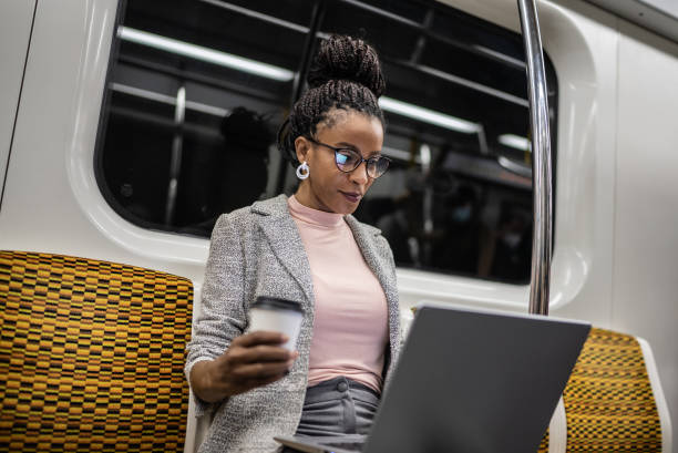 Mature woman using the laptop in the subway train