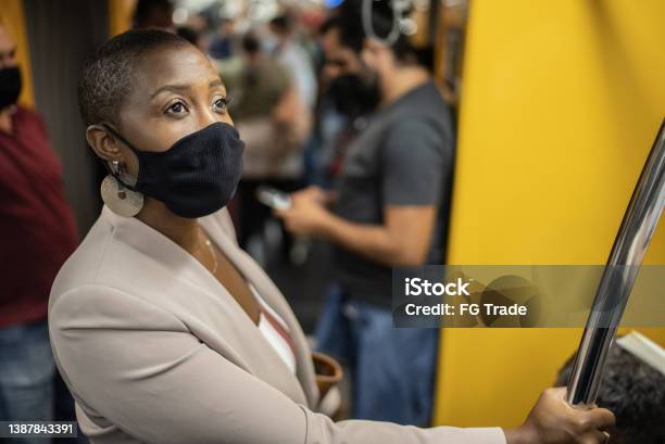 Businesswoman in the subway train - wearing a face mask