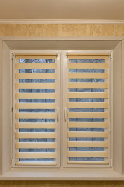 istock window half closed with striped blinds day-night 1387845737