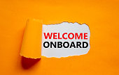 Welcome onboard onboarding symbol. Concept words Welcome onboard appearing behind torn orange paper. Beautiful orange background. Business, welcome onboard onboarding concept, copy space.
