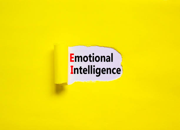 istock EI emotional intelligence symbol. Concept words EI emotional intelligence on yellow paper on a beautiful yellow table white background. Business EI emotional intelligence concept, copy space. 1387847353