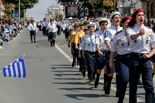 Limassol, Cyprus, March 25th, 2022: Scout group in uniform marching along Archbishop Makarios III Avenue during the Greek Independence Day parade