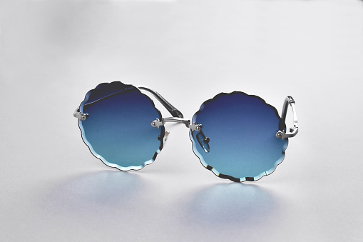 Glasses from the sun, stylish sunglasses on a gray background, close-up selective focus