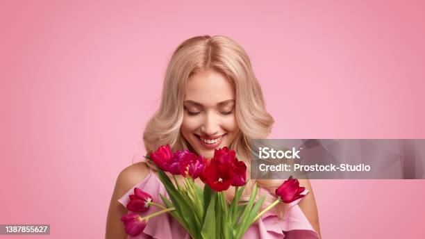Happy Blonde Female Holding Bouquet Of Tulips Over Pink Background Stock Photo - Download Image Now
