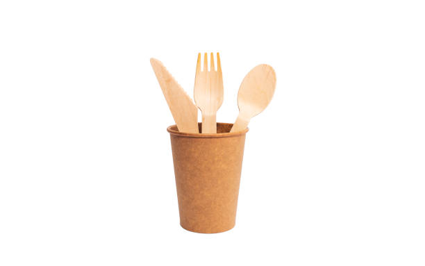 istock Eco brown cup and wooden khife, fork, spoon on a white background. Mockup for your and copy space 1387857761
