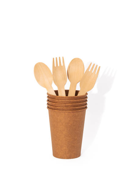 istock Eco brown cup and wooden khife, fork, spoon on a white background. Mockup for your and copy space 1387857763