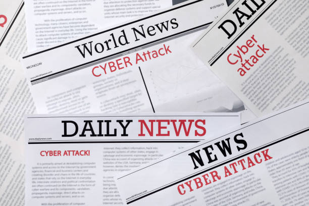 istock Newspapers with headlines Cyber Attack as background, closeup 1387857834
