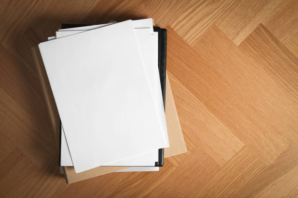 istock Stack of blank paper on wooden background, top view. Space for text 1387857845