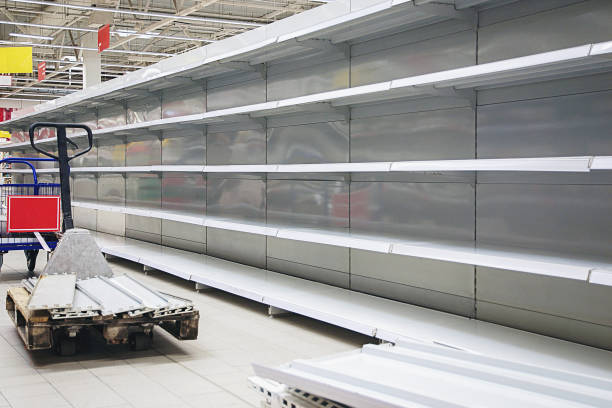 istock Empty shelves and pallet jack in grocery store 1387857877
