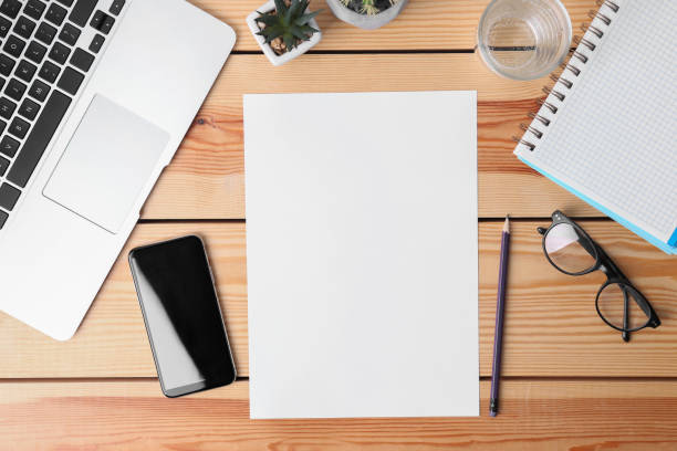 istock Flat lay composition with blank paper sheet on wooden background. Space for text 1387857887
