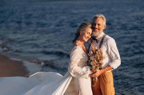 istock Senior newlyweds hug. 1387858739
