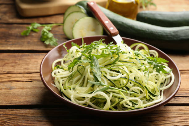 istock Tasty zucchini pasta with arugula on wooden table 1387858795
