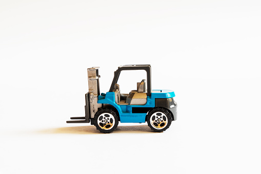 Fork lift truck toy on the white background.