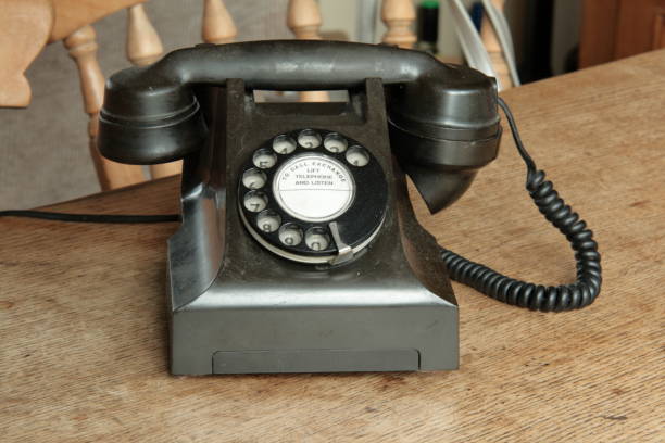 Analogue telephone Old Bakelite rotary dial telephone on a wooden table bakelite stock pictures, royalty-free photos & images