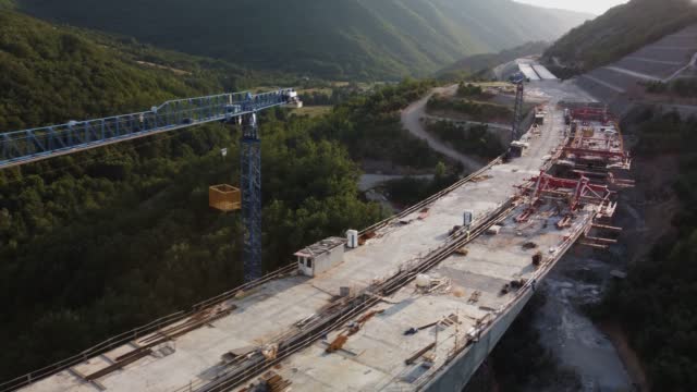 Highway bridge under construction. Aerial view of nes road. Freeway being built on a mountain terrain..