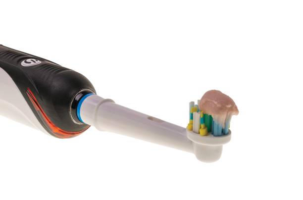 istock Close up view of automatic toothbrush head with toothpaste isolated on white background. Sweden. 1387862238