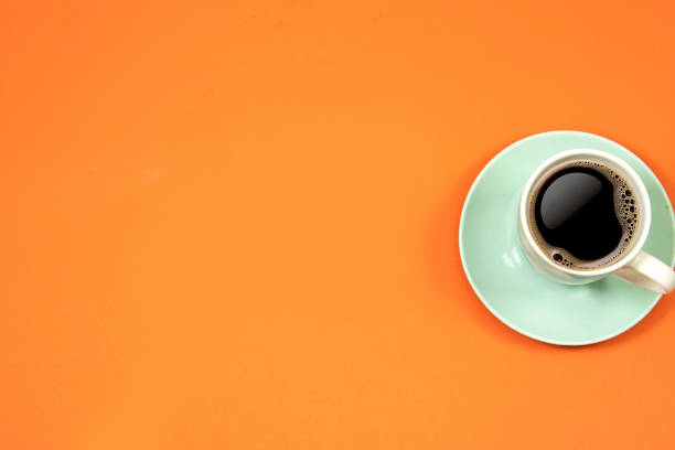 istock cup of coffee isolated on orange background.  hello Monday concept , back to work 1387862567