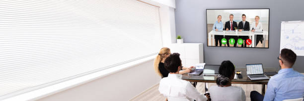 istock Businesspeople Discussing Graphs Through Videochat 1387865960