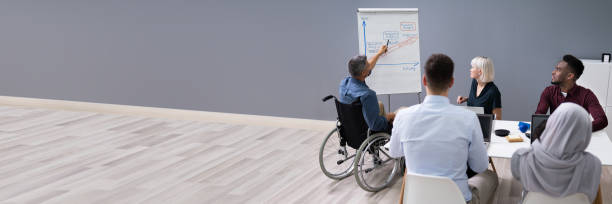 istock Disables Businessman Giving Presentation 1387865982