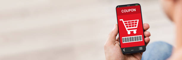 istock Man's Hand Holding Cell Phone With Blank Screen 1387866196