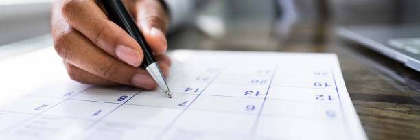 Calendar Deadline Calendar Deadline. Young Man Holding Pen Marking Date calendar date circled stock pictures, royalty-free photos & images