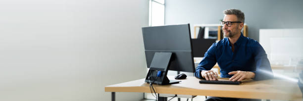 Businessman Using Business Computer In Office Businessman Using Business Computer In Office Or Workplace desktop pc stock pictures, royalty-free photos & images