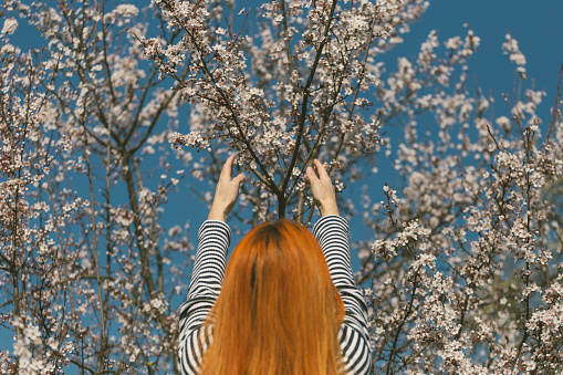 Happy adult female enjoys beginning of springtime