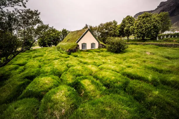 Photo of Amazing view of turf church Hofskirkja. Location place of Iceland, small village Hof, Europe.