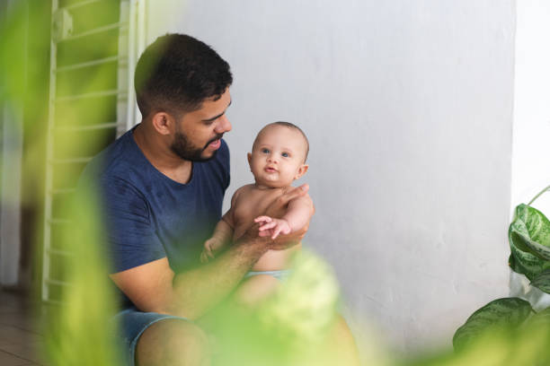 istock Father sitting with baby at home 1387868757