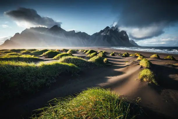 Unique view on the green hills with sand dunes. Location Stokksnes cape, Vestrahorn (Batman Mount), Iceland, Europe. Scenic image of amazing nature capture. Summer scene. Discover the beauty of earth.