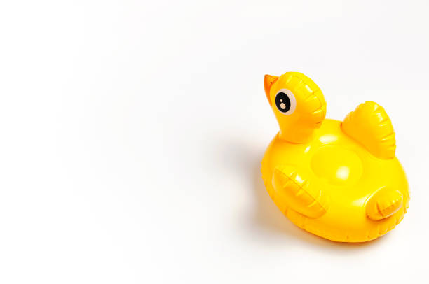 istock Inflatable mini yellow chicken or duckling on white background, pool float party. Flat lay copy space. Trend Inflatable Children toy for swimming. Creative summer beach concept. Layout for design 1387870309