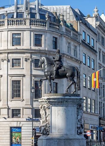 Charles I Monument at Trafalgar Square in Whitehall, London . Uganda House is in the background.