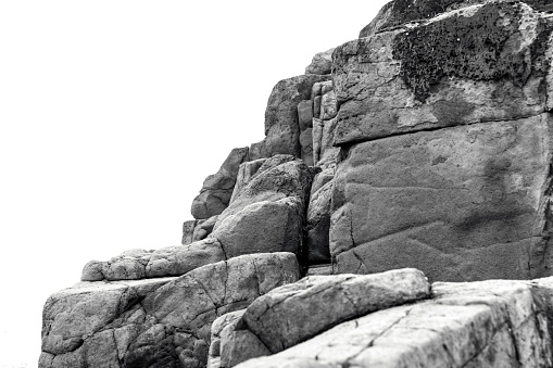 Black and white Basaltic volcanic columns, Bongo NSW Australia, white background with copy space, full frame horizontal composition