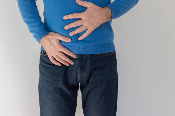 istock Old man feeling big discomfort in stomach. 1387875521