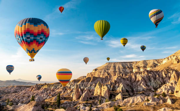 Hot air balloon flying over spectacular Cappadocia, Uchisar - Goreme, Turkey Hot air balloon flying over spectacular Cappadocia, Uchisar - Goreme, Turkey hot air balloon stock pictures, royalty-free photos & images