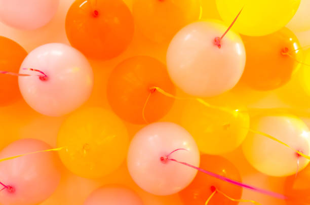 orange helium balloons, reflections from puddles of water, good for art articles