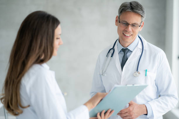 istock Two healthcare workers talking at hospital 1387880428