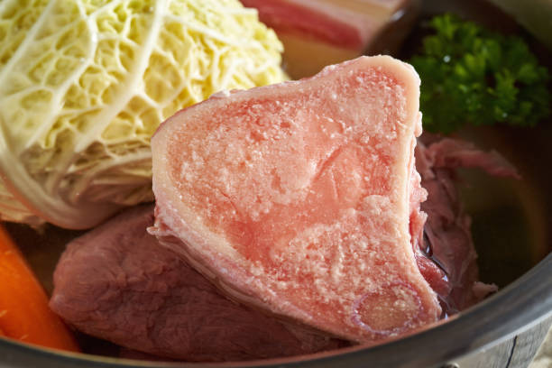 istock Preparation of bone broth - marrow bones and vegetables in a pot 1387882179