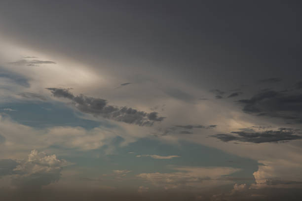 istock The sun shines through the clouds in the evening sky with dramatic light. 1387900874