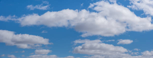 Cumulus Clouds in a Blue Sky Cumulus clouds appear in a blue sky over Walnut Canyon Lakes in Flagstaff, Arizona, USA. jeff goulden panoramic stock pictures, royalty-free photos & images