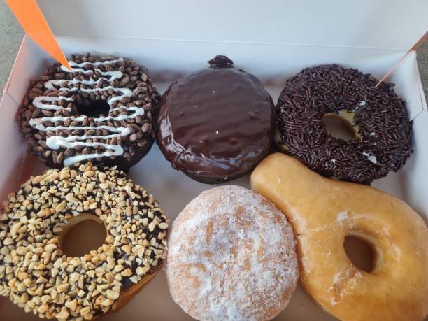 istock various shapes and flavors of donuts in donut box packaging 1387904592